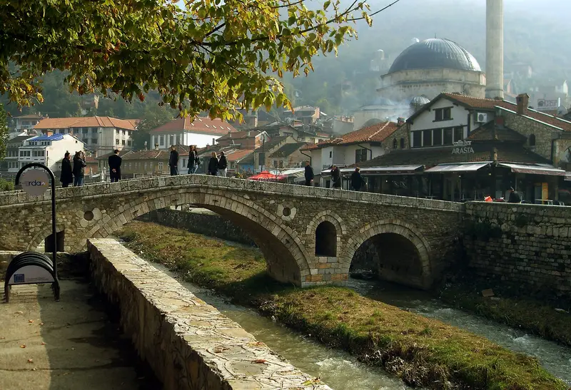 The Stone Bridge over the Bistrica in Prizren, with the Sinan Pasha Mosque dome behind